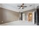 A carpeted bedroom with a ceiling fan, closet, and warm, neutral color palette at 19627 Spring Oak Dr, Eustis, FL 32736
