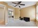 A carpeted bedroom with a ceiling fan, closet, and large window at 19627 Spring Oak Dr, Eustis, FL 32736
