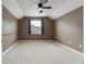 A carpeted room with a ceiling fan, window, and neutral color scheme at 19627 Spring Oak Dr, Eustis, FL 32736