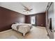 A comfortable bedroom with neutral carpet and rich brown walls at 19627 Spring Oak Dr, Eustis, FL 32736