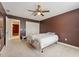 Cozy bedroom featuring soft carpet, a ceiling fan, and a spacious closet at 19627 Spring Oak Dr, Eustis, FL 32736