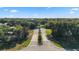 Community entrance showcasing landscaping and mature trees at 19627 Spring Oak Dr, Eustis, FL 32736