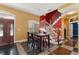 Bright dining area featuring stairs, dark wood floors, and lots of natural light at 19627 Spring Oak Dr, Eustis, FL 32736