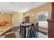 Open-concept dining area with sleek floors, large windows, and pendant lighting at 19627 Spring Oak Dr, Eustis, FL 32736