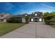 Charming two-story home with a well-manicured lawn, long driveway and attached garage at 19627 Spring Oak Dr, Eustis, FL 32736