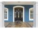Close-up of elegant front door with glass inserts and white trim detailing at 19627 Spring Oak Dr, Eustis, FL 32736