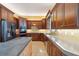 Modern kitchen with dark cabinets, concrete countertops, and stainless steel appliances at 19627 Spring Oak Dr, Eustis, FL 32736