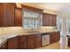 Kitchen featuring wood cabinets, stainless steel appliances and a window view to the backyard at 19627 Spring Oak Dr, Eustis, FL 32736