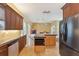 Open kitchen with stainless steel appliances, island, bar seating and adjacent living space at 19627 Spring Oak Dr, Eustis, FL 32736