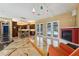 Open living room with fireplace, bar seating, and French door access to pool at 19627 Spring Oak Dr, Eustis, FL 32736