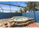 A relaxing screened-in spa with a waterfall feature and stone accents at 19627 Spring Oak Dr, Eustis, FL 32736