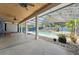 A covered patio overlooking a sparkling pool and beautifully landscaped backyard creates a tranquil oasis at 19627 Spring Oak Dr, Eustis, FL 32736