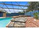 Stone-laid sunning platform near the pool and spa adds to the beauty of this backyard at 19627 Spring Oak Dr, Eustis, FL 32736