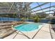 Backyard pool with waterfall feature, stone accents, and screened-in enclosure at 19627 Spring Oak Dr, Eustis, FL 32736