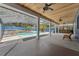 Covered outdoor pool and patio area with a waterfall feature, perfect for entertaining at 19627 Spring Oak Dr, Eustis, FL 32736