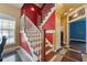 Inviting staircase with wood steps, white railings, and colorful accent walls at 19627 Spring Oak Dr, Eustis, FL 32736
