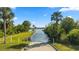 Scenic view of the water access and boat ramp, framed by lush greenery and a clear blue sky at 19627 Spring Oak Dr, Eustis, FL 32736