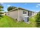 View of the backyard showcasing the home's exterior and the lush green lawn at 2015 Palo Alto Ave, The Villages, FL 32159