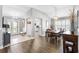 Open concept dining area with wood floors, modern light fixture and views to entry and the kitchen at 2015 Palo Alto Ave, The Villages, FL 32159