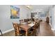 Spacious dining room featuring a dark wood table, leather chairs, and a modern chandelier and painting at 2015 Palo Alto Ave, The Villages, FL 32159