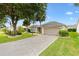 Charming home featuring manicured landscaping, a spacious driveway, and a two-car garage at 2015 Palo Alto Ave, The Villages, FL 32159
