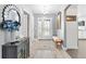 Welcoming foyer featuring tile floors, a modern mirror, and a glass-paneled front door at 2015 Palo Alto Ave, The Villages, FL 32159