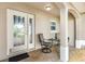 Cozy front porch featuring a decorative glass door, seating, and neutral-toned finishes at 2015 Palo Alto Ave, The Villages, FL 32159