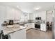The kitchen is open and bright with stainless appliances and granite countertops at 2015 Palo Alto Ave, The Villages, FL 32159