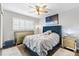 Comfortable bedroom featuring a ceiling fan, large window, and stylish furniture creating a relaxing retreat at 2015 Palo Alto Ave, The Villages, FL 32159