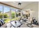 Enclosed sunroom with comfortable seating, natural light, and scenic outdoor views, perfect for relaxation and enjoyment at 2015 Palo Alto Ave, The Villages, FL 32159