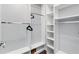 Spacious walk-in closet with custom shelving and hanging rods offers ample storage space and organization at 2015 Palo Alto Ave, The Villages, FL 32159