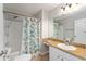 Bathroom with seashell shower curtain, updated vanity, and neutral tones at 2022 Claudio Ln, The Villages, FL 32159