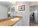 Bathroom with updated granite vanity and a peek into the bedroom at 2022 Claudio Ln, The Villages, FL 32159