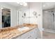 Bathroom with a granite countertop, modern vanity, and a glass-enclosed shower at 2022 Claudio Ln, The Villages, FL 32159