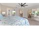Spacious primary bedroom with access to an ensuite bathroom, dining area, and sunroom at 2022 Claudio Ln, The Villages, FL 32159