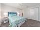Bedroom with plush carpet, blue accents, and a view into the living area at 2022 Claudio Ln, The Villages, FL 32159