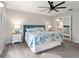 Comfortable bedroom with a large bed, modern ceiling fan, and an ensuite bathroom entrance at 2022 Claudio Ln, The Villages, FL 32159