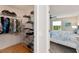 Organized walk-in closet connected to a well-lit bedroom with stylish decor at 2022 Claudio Ln, The Villages, FL 32159