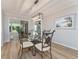 Bright dining room with decorative chandelier and glass table near sliding doors to the sun room at 2022 Claudio Ln, The Villages, FL 32159