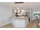 Kitchen bar with granite counter top, stainless appliances and modern pendant lighting at 2022 Claudio Ln, The Villages, FL 32159