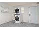 Convenient laundry area featuring a modern, stacked washer and dryer setup at 2022 Claudio Ln, The Villages, FL 32159