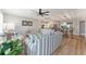 Open-concept living area with modern furnishings, wood flooring, and a view into the kitchen and dining space at 2022 Claudio Ln, The Villages, FL 32159