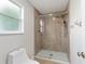 Modern bathroom with a glass-enclosed shower featuring stylish fixtures and a window at 2022 Claudio Ln, The Villages, FL 32159
