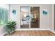 Bright sunroom reflecting the bedroom through a large sliding glass door, artwork, and a plant at 2022 Claudio Ln, The Villages, FL 32159