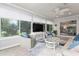Inviting sunroom with large windows, stylish furniture, and a view of the garden and bedroom at 2022 Claudio Ln, The Villages, FL 32159