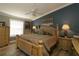 Inviting bedroom with dark blue accent wall, wooden furniture and ceiling fan at 2039 Thurmond Ave, The Villages, FL 32162