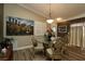 Elegant dining room with stylish chandelier, decorative wall art and luxury chair design at 2039 Thurmond Ave, The Villages, FL 32162