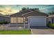 Charming single-story home featuring a well-manicured lawn and attached two-car garage at 2039 Thurmond Ave, The Villages, FL 32162