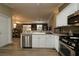Bright kitchen featuring white cabinets and stainless steel appliances at 2039 Thurmond Ave, The Villages, FL 32162