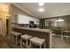 Well-equipped kitchen with white cabinets, breakfast bar and stainless steel appliances at 2039 Thurmond Ave, The Villages, FL 32162